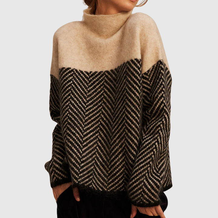 A woman wearing a zigzag-pattern funnel neck jumper styled elegantly for an autumn day out.
