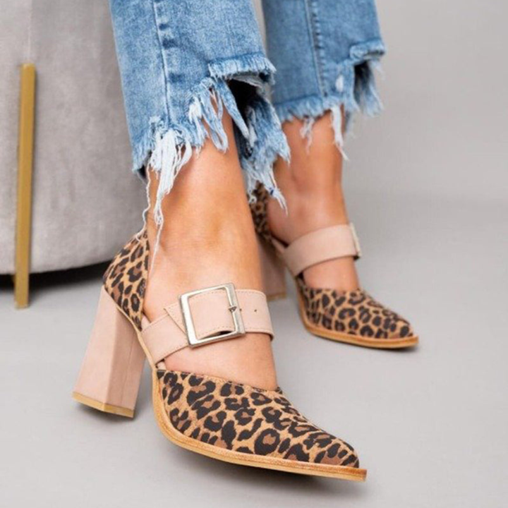 A woman wearing pointed khaki heels, stepping out in a polished day-to-evening outfit.
