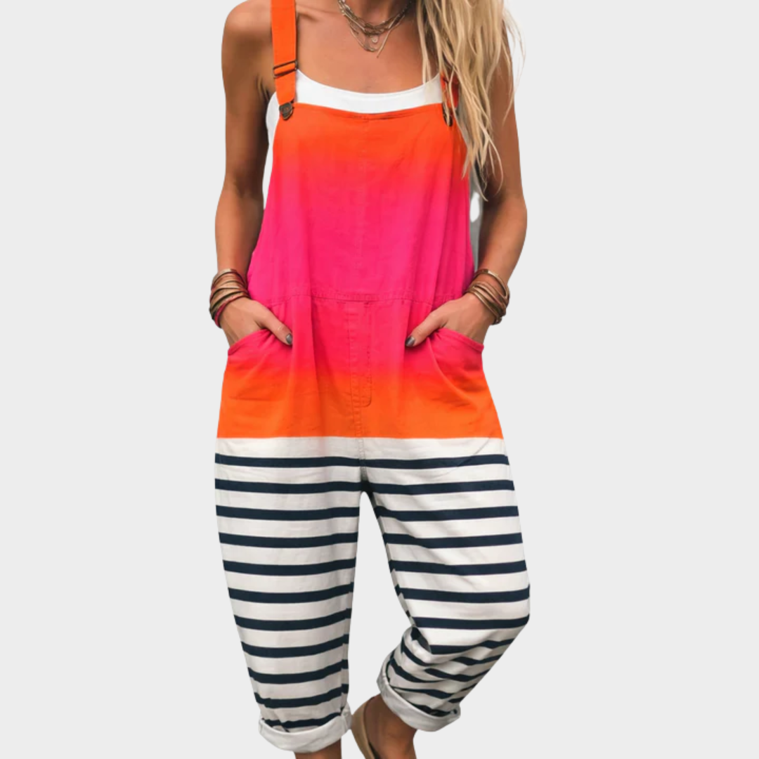 Woman wearing dungarees with an orange-to-pink gradient top and navy-and-white striped legs