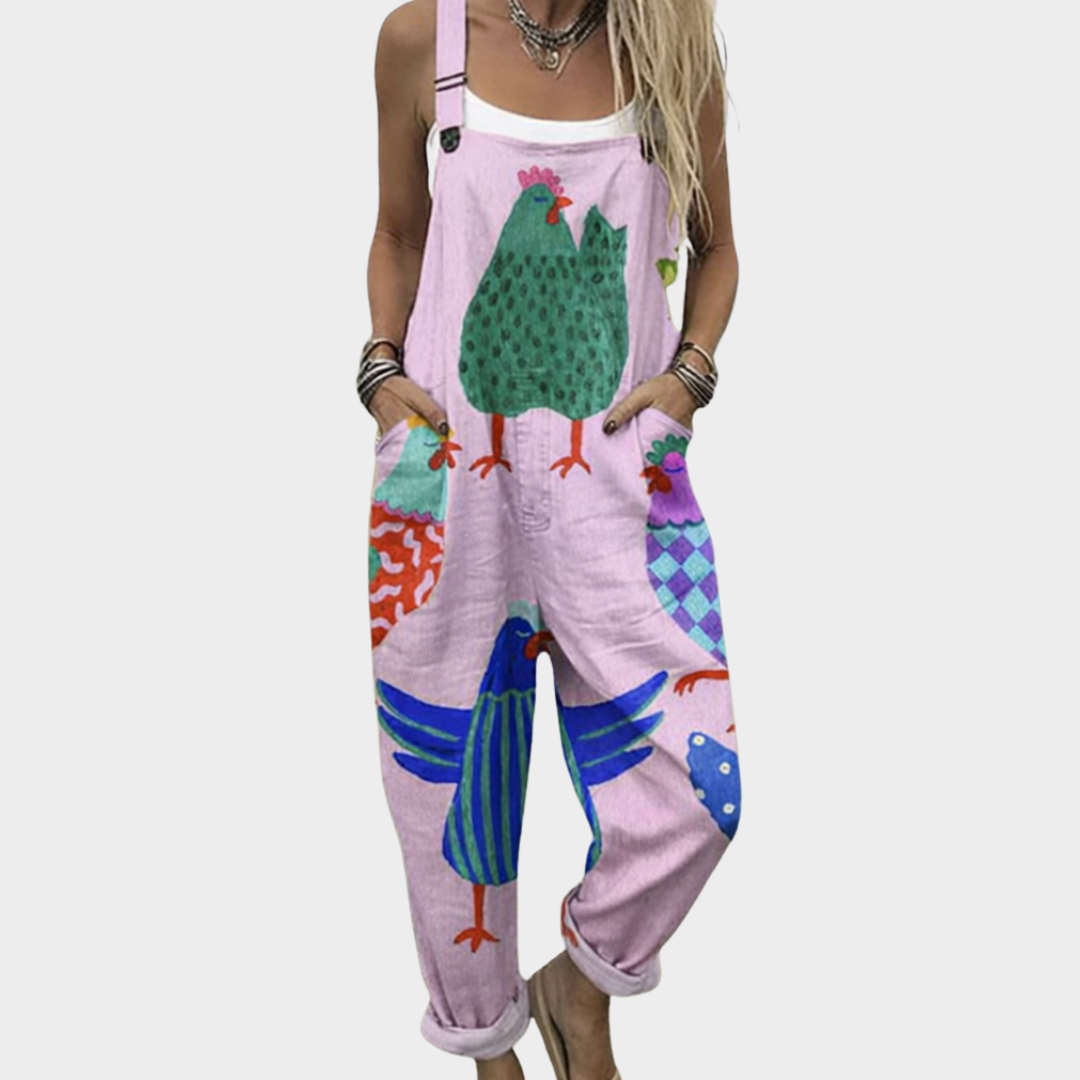 Woman wearing soft pink dungarees printed with big patterned hens in green and blue