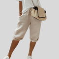 Wide-leg high-waist trousers in a neutral beige tone