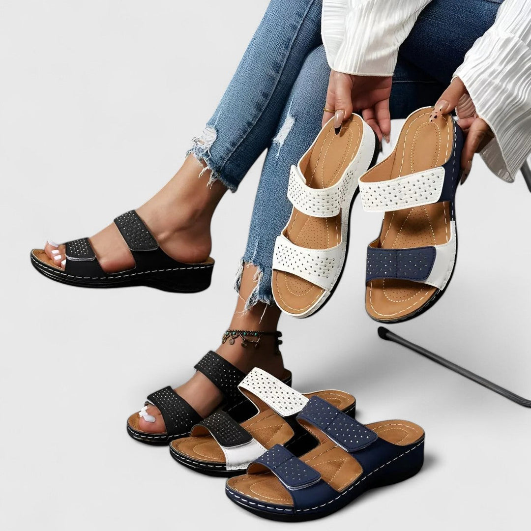 A woman walking confidently in wide-fit comfort sandals with a cushioned, supportive footbed.