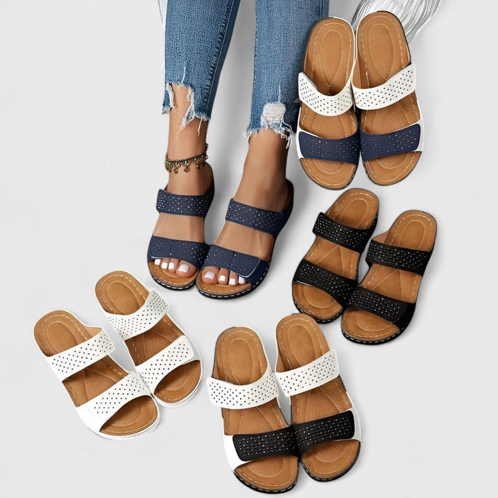 A woman walking confidently in wide-fit comfort sandals with a cushioned, supportive footbed.