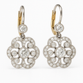 A pair of retro-style drop earrings with an intricate mandala pattern and crystal detailing