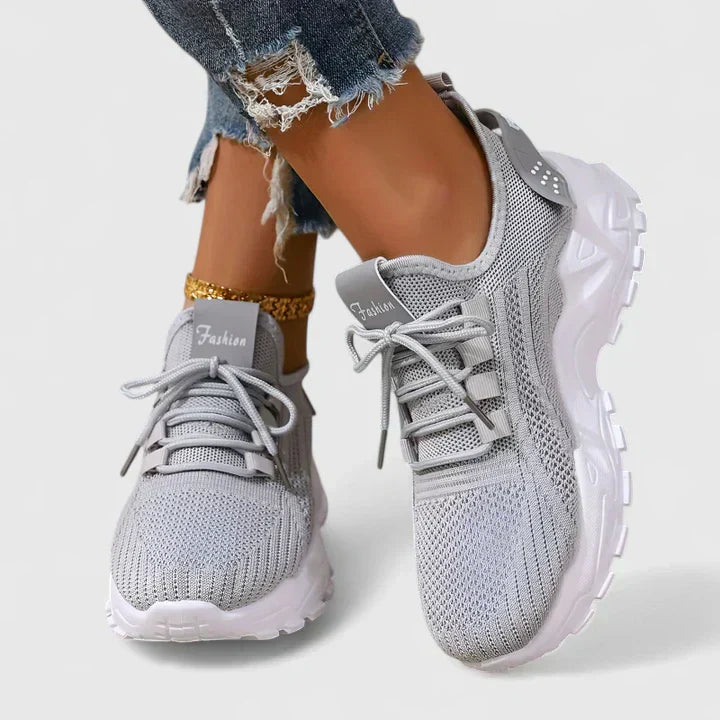 A woman wearing wide-toe cushioned orthopaedic trainers