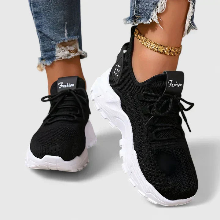A woman wearing wide-toe cushioned orthopaedic trainers