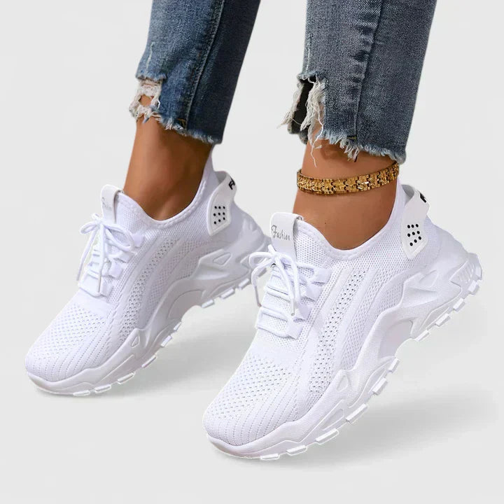 A woman wearing wide-toe cushioned orthopaedic trainers