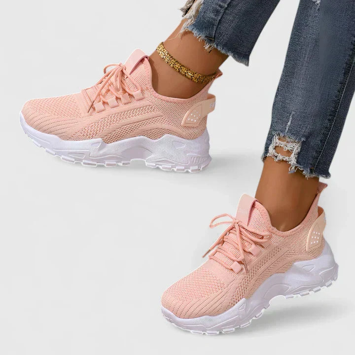 A woman wearing wide-toe cushioned orthopaedic trainers