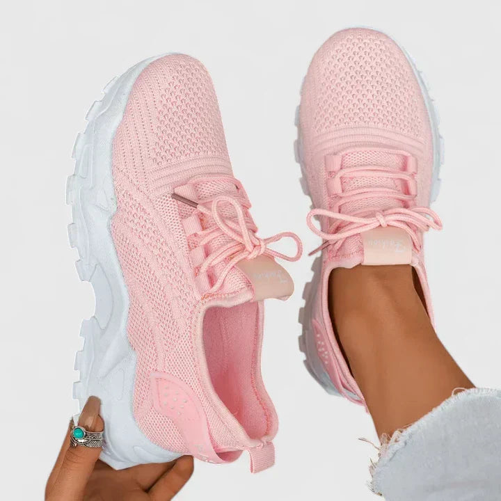 A woman wearing wide-toe cushioned orthopaedic trainers