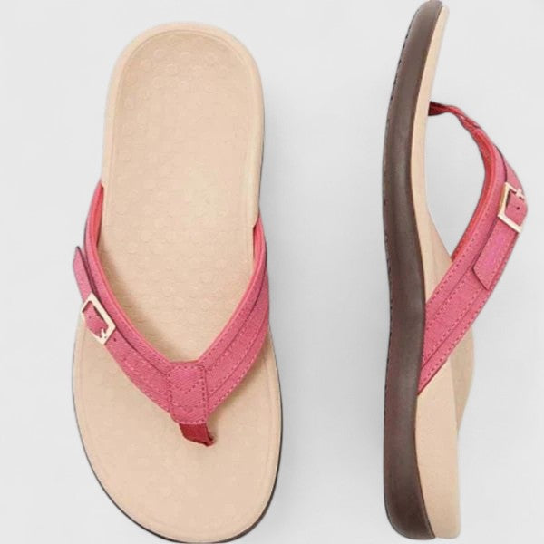 A woman in light blue lightweight flip-flops relaxing on a sunny terrace, feet light and comfortable.