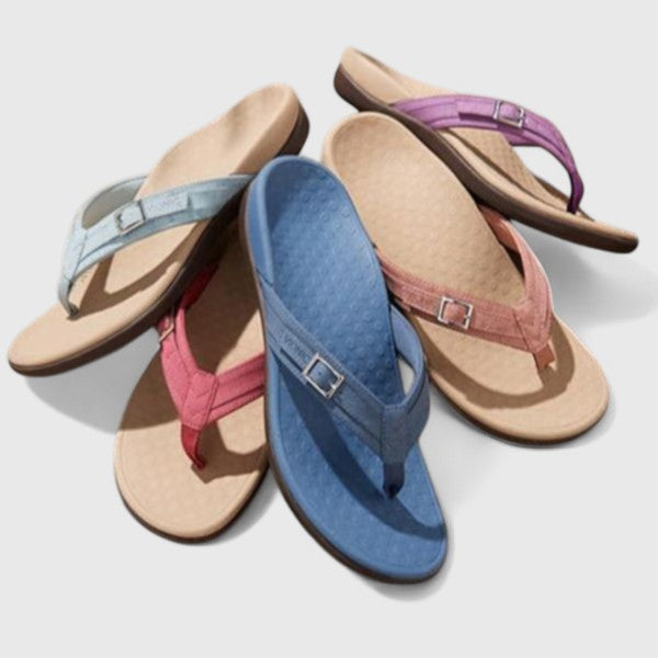 A woman in light blue lightweight flip-flops relaxing on a sunny terrace, feet light and comfortable.