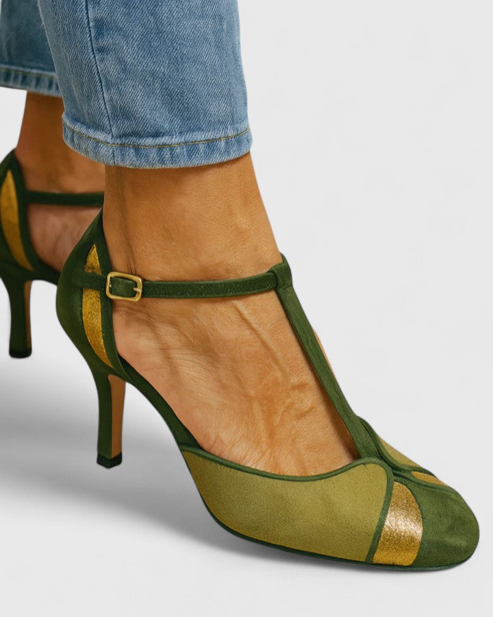 A woman wearing green open ankle-strap heels, stepping out in a bright, elegant look.