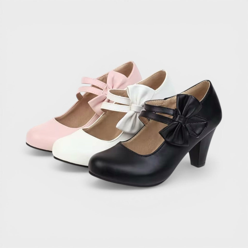Women's mid-height heels in black with a soft delicate bow at the toe