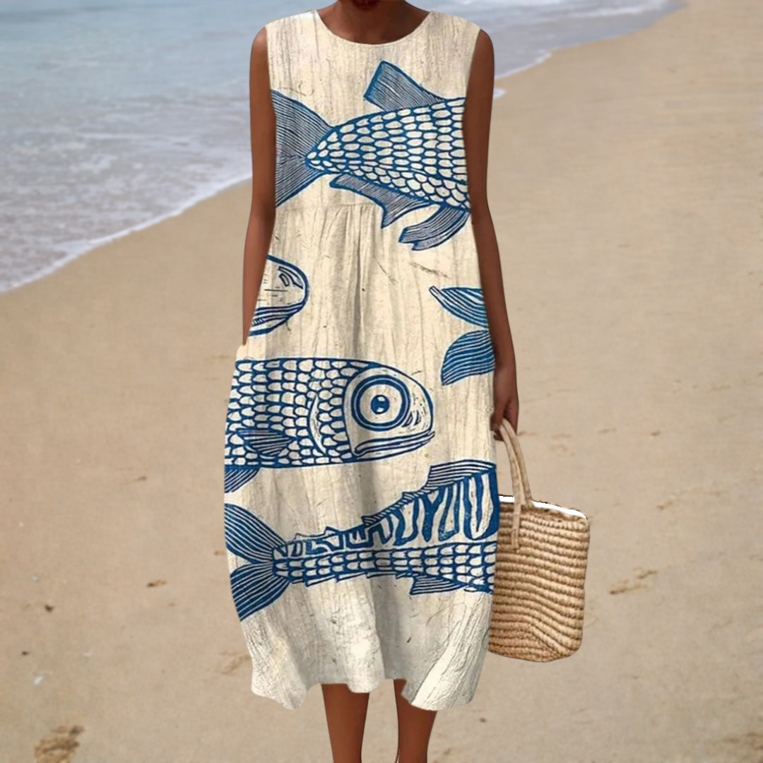 A woman wearing a printed, sleeveless summer dress that flows loosely on a warm day.