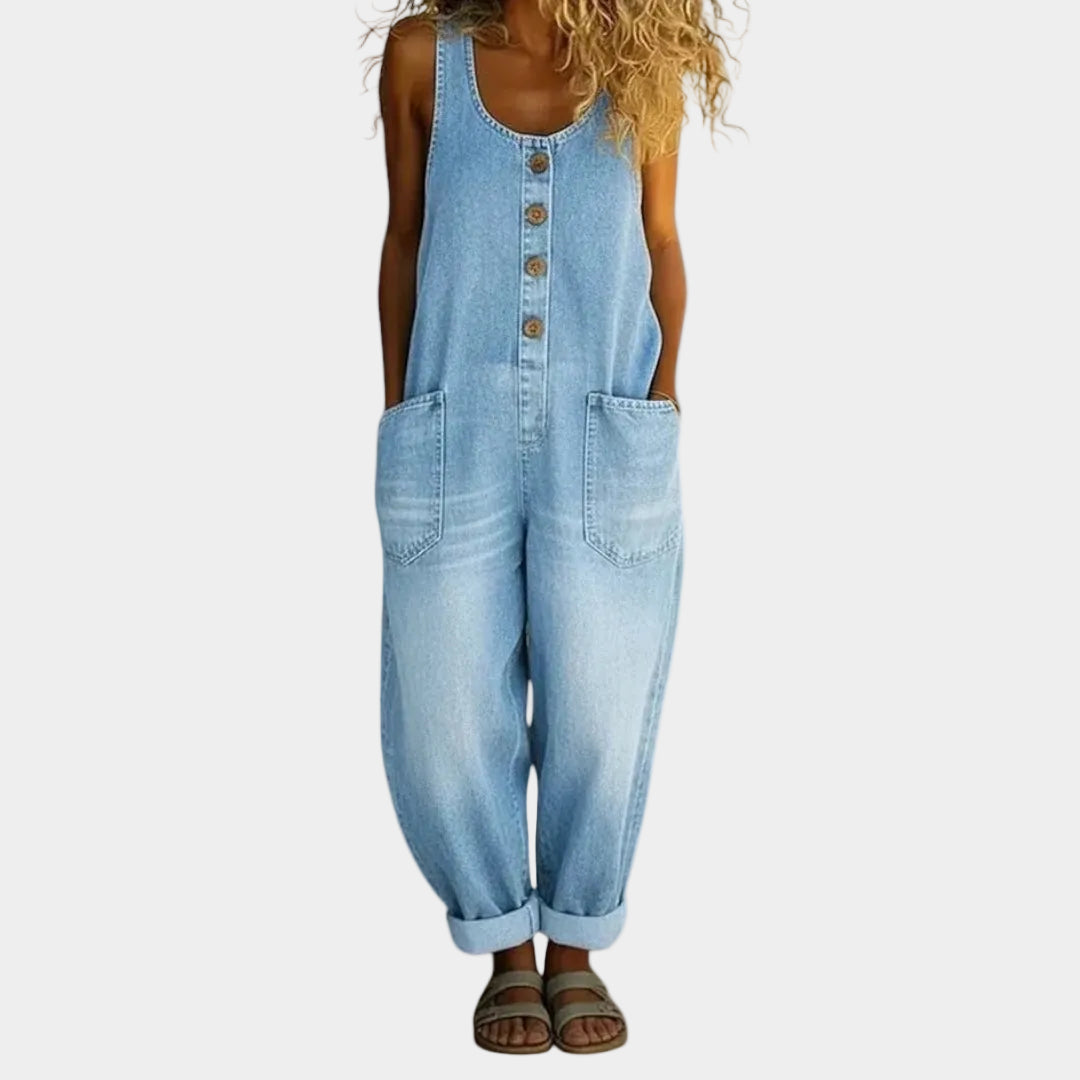 A woman wearing light blue wide-leg vintage dungarees with a buttoned front and roomy patch pockets.