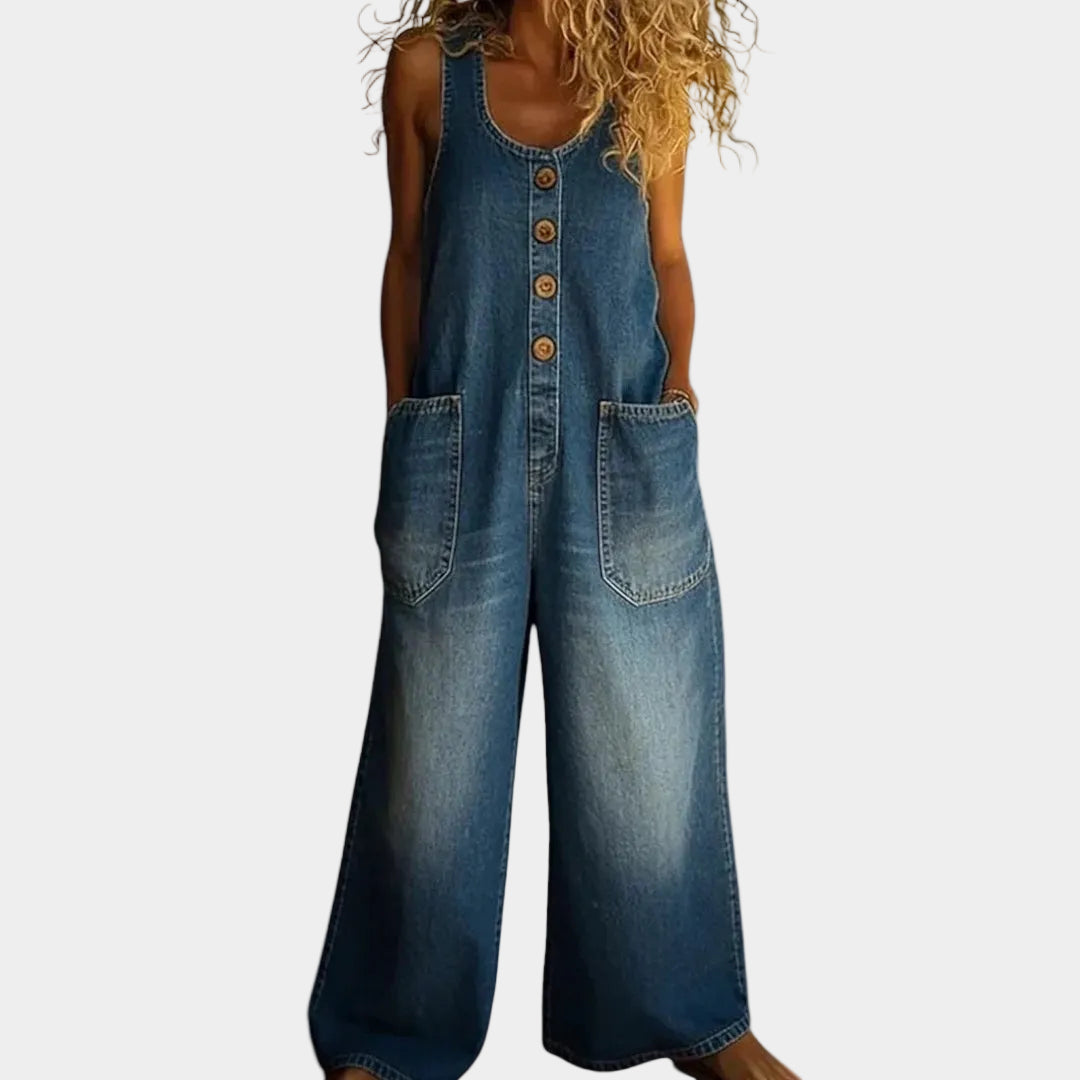A woman wearing light blue wide-leg vintage dungarees with a buttoned front and roomy patch pockets.