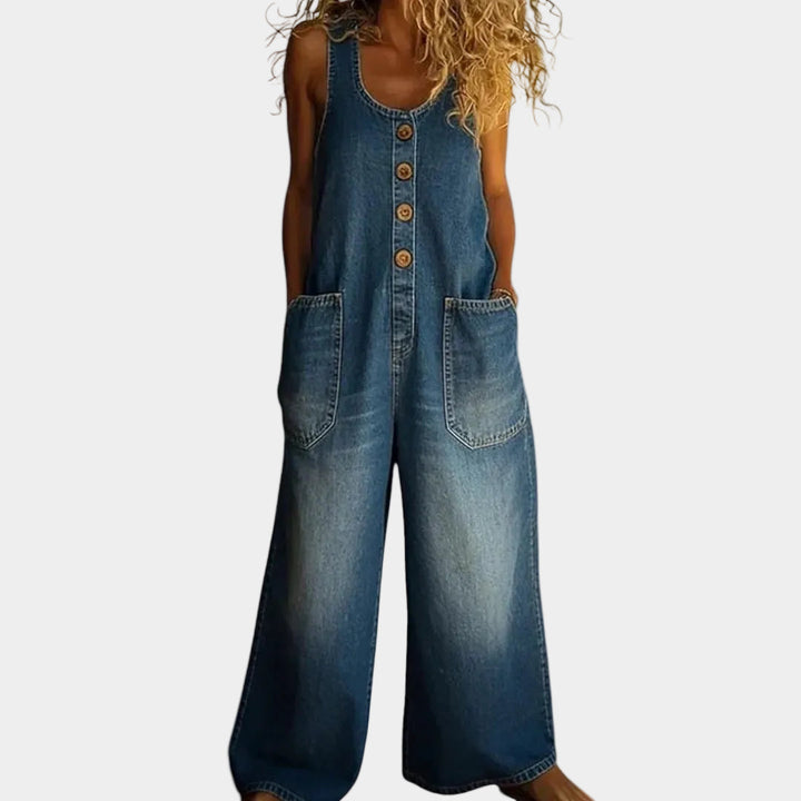 A woman wearing light blue wide-leg vintage dungarees with a buttoned front and roomy patch pockets.
