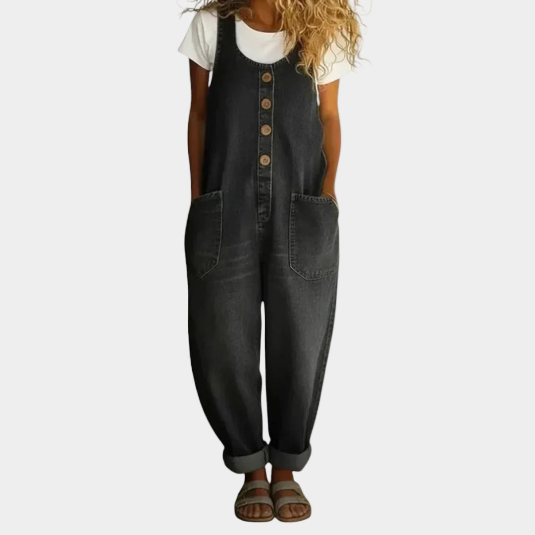 A woman wearing light blue wide-leg vintage dungarees with a buttoned front and roomy patch pockets.