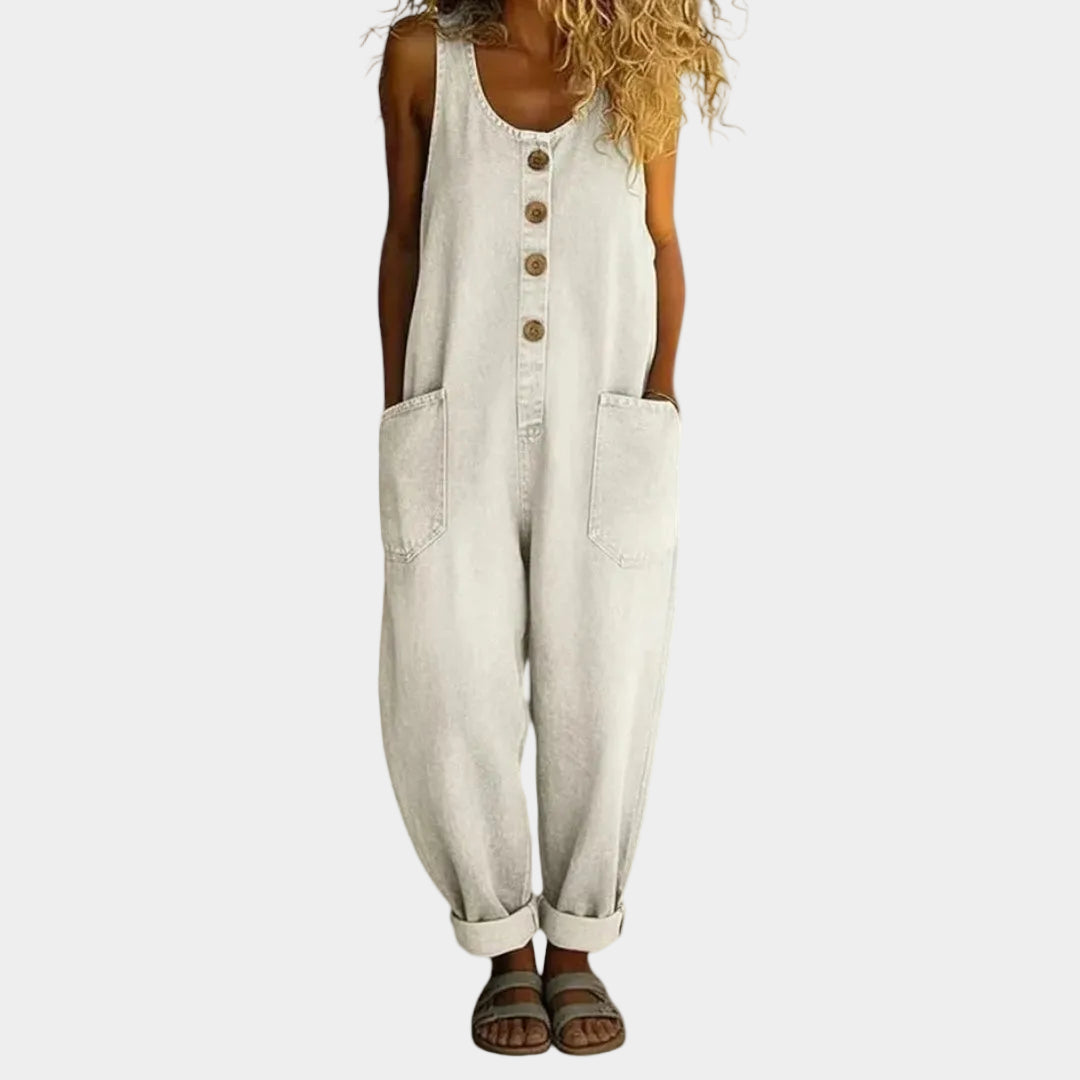 A woman wearing light blue wide-leg vintage dungarees with a buttoned front and roomy patch pockets.