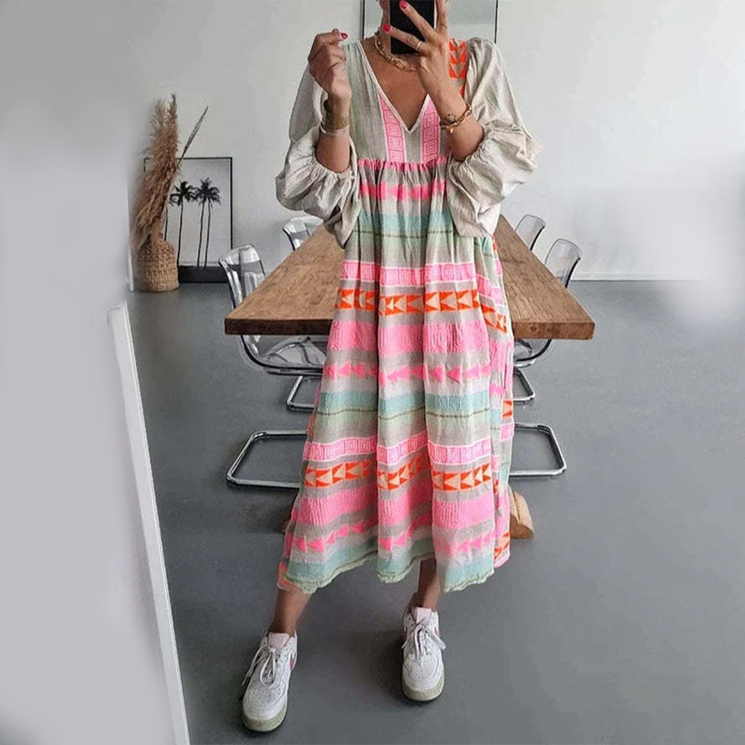 Woman wearing the Noreen™ colourful geometric print boho dress with puffed sleeves, out enjoying a casual day.
