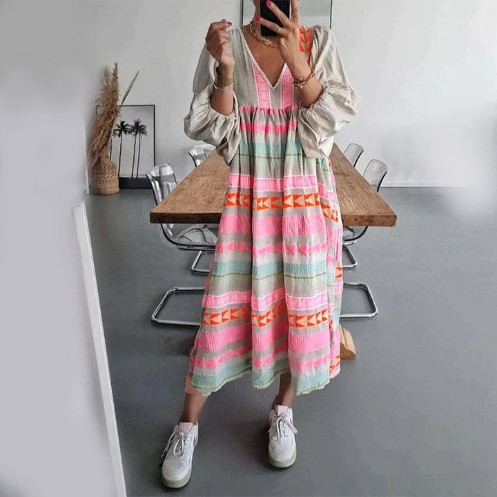 Woman wearing the Noreen™ colourful geometric print boho dress with puffed sleeves, out enjoying a casual day.