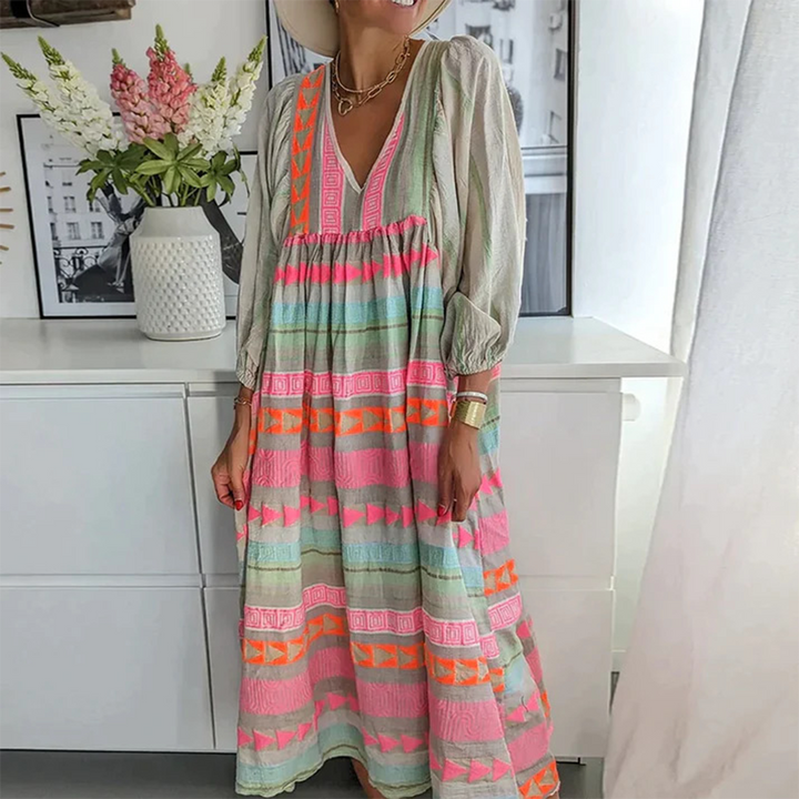Woman wearing the Noreen™ colourful geometric print boho dress with puffed sleeves, out enjoying a casual day.