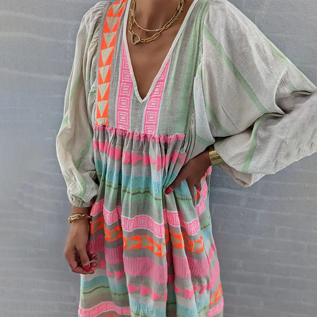 Woman wearing the Noreen™ colourful geometric print boho dress with puffed sleeves, out enjoying a casual day.