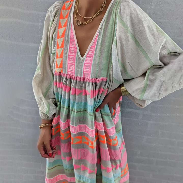 Woman wearing the Noreen™ colourful geometric print boho dress with puffed sleeves, out enjoying a casual day.