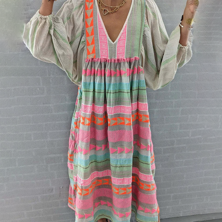Woman wearing the Noreen™ colourful geometric print boho dress with puffed sleeves, out enjoying a casual day.