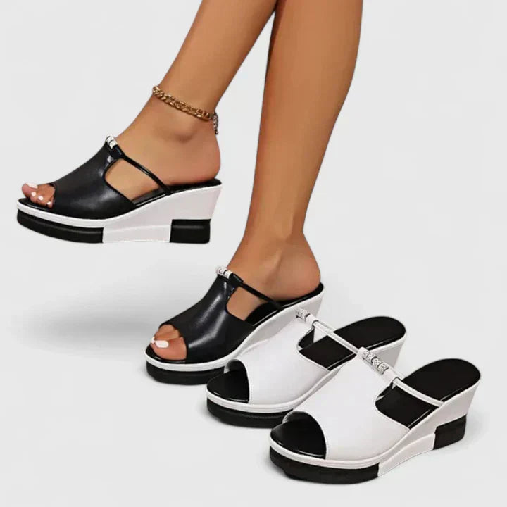 A woman standing confidently in white chic support sandals with a broad, cushioned base.