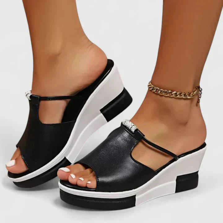 A woman standing confidently in white chic support sandals with a broad, cushioned base.