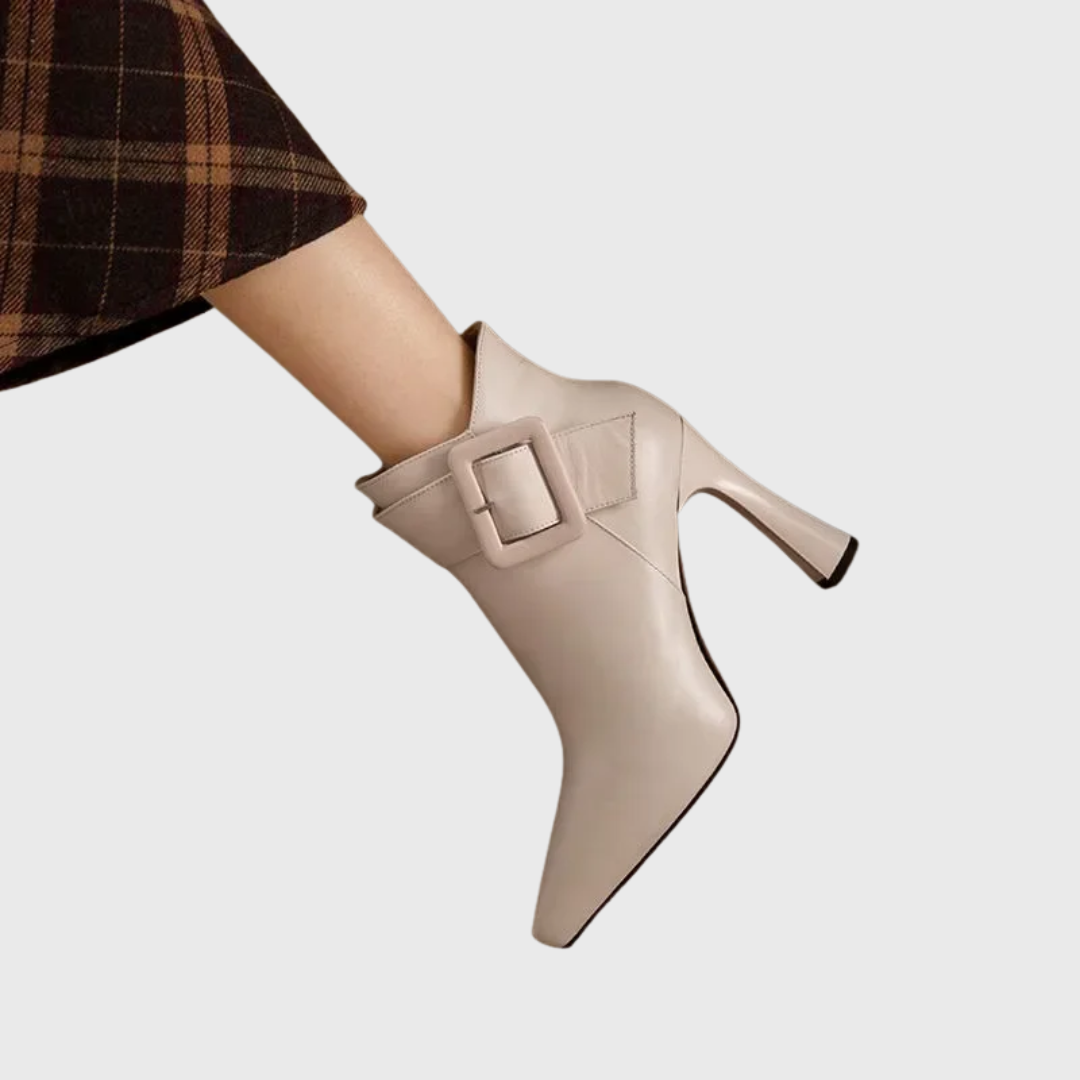 Sleek heeled ankle boots in beige and black with a side zip and structured silhouette
