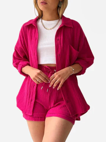 A woman wearing a soft V-neck blouse with matching playful shorts, fresh and relaxed.