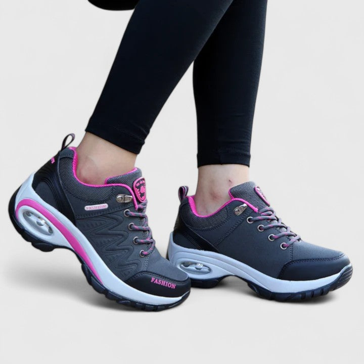 A woman wearing water-resistant comfort trainers on a wet winter day