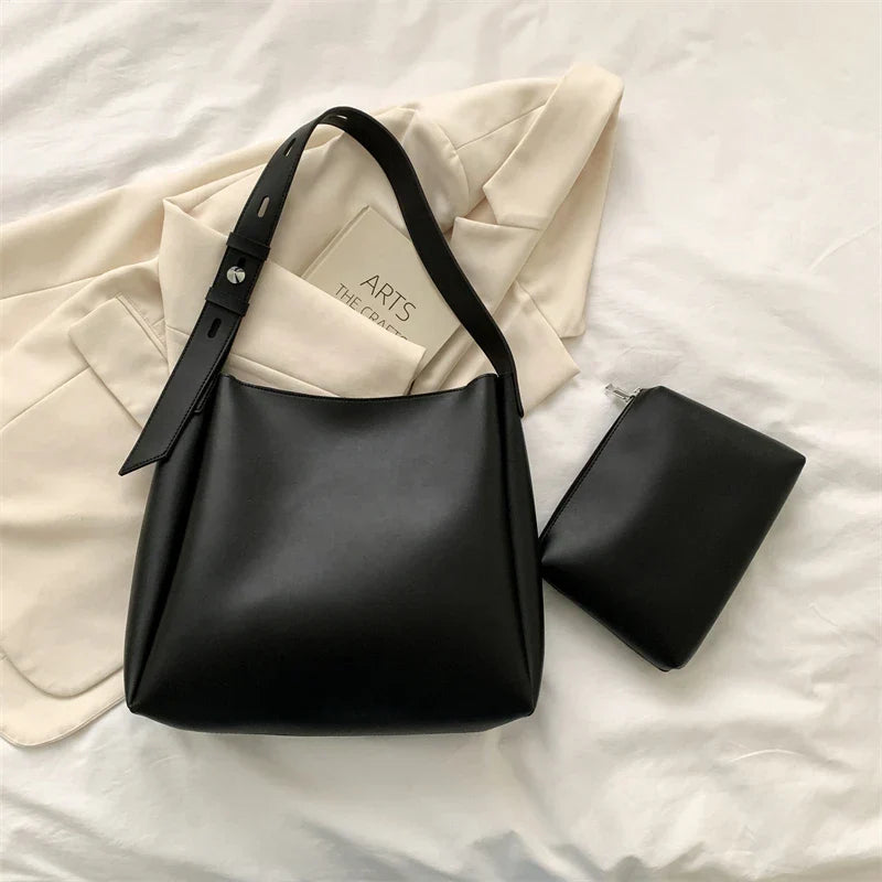 Elegant structured tote bag in black with clean minimalist lines and comfortable shoulder strap