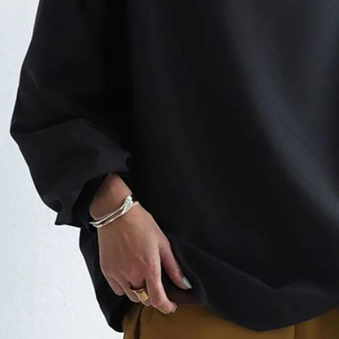 A woman wearing a soft funnel neck jumper styled with jeans for a relaxed elegant look.
