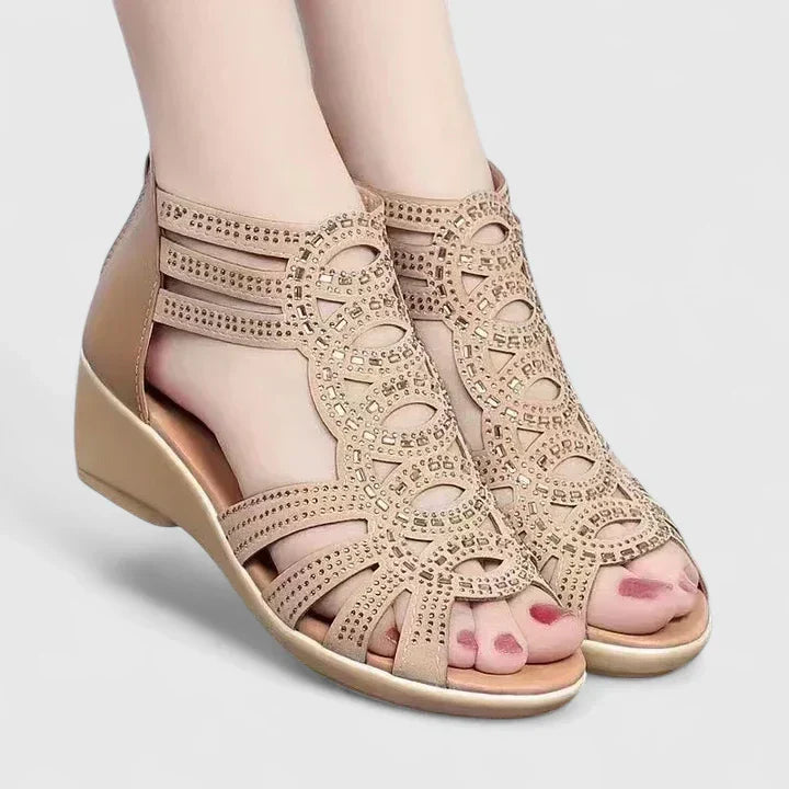 A woman's black caged wedge sandals with sparkle detail, an open toe and a back zip.