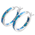 A pair of handcrafted drop earrings featuring natural opal stones with shifting blue and green hues