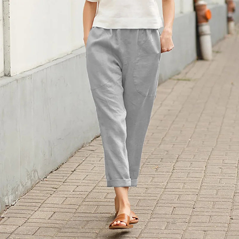 A woman wearing wide relaxed trousers with two roomy pockets and an elastic waist.