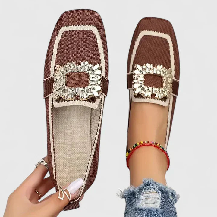 A woman wearing embellished comfort flats with a sparkling jewelled square buckle
