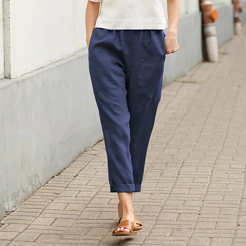 A woman wearing wide relaxed trousers with two roomy pockets and an elastic waist.