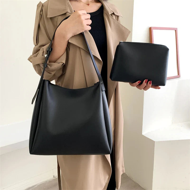 Elegant structured tote bag in black with clean minimalist lines and comfortable shoulder strap