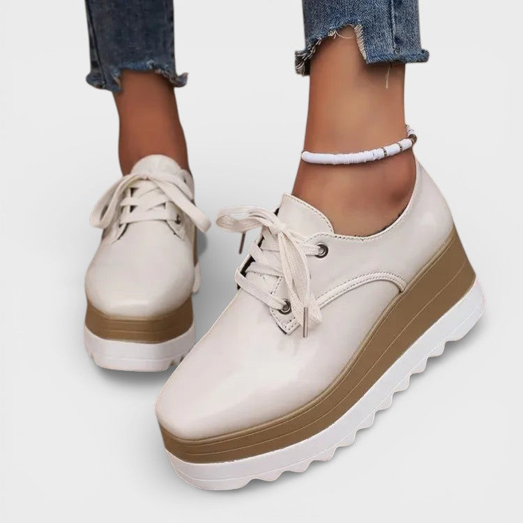 Women's platform trainers in beige with a cushioned sole and glossy contemporary finish