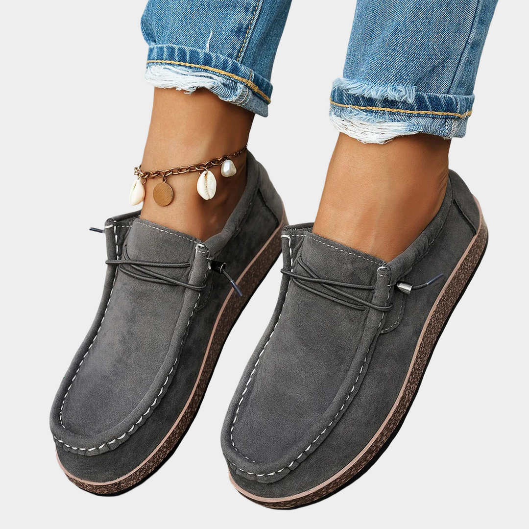 A woman wearing grey boho-print lace-up comfort shoes on an everyday walk.