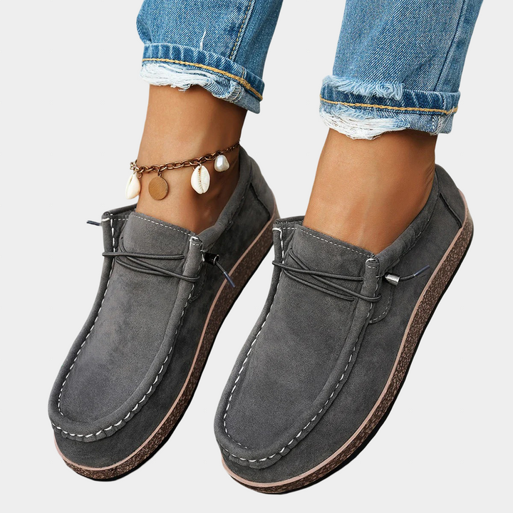 A woman wearing grey boho-print lace-up comfort shoes on an everyday walk.