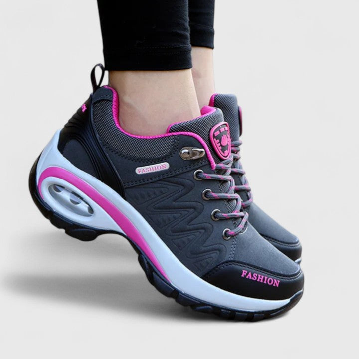 A woman wearing water-resistant comfort trainers on a wet winter day