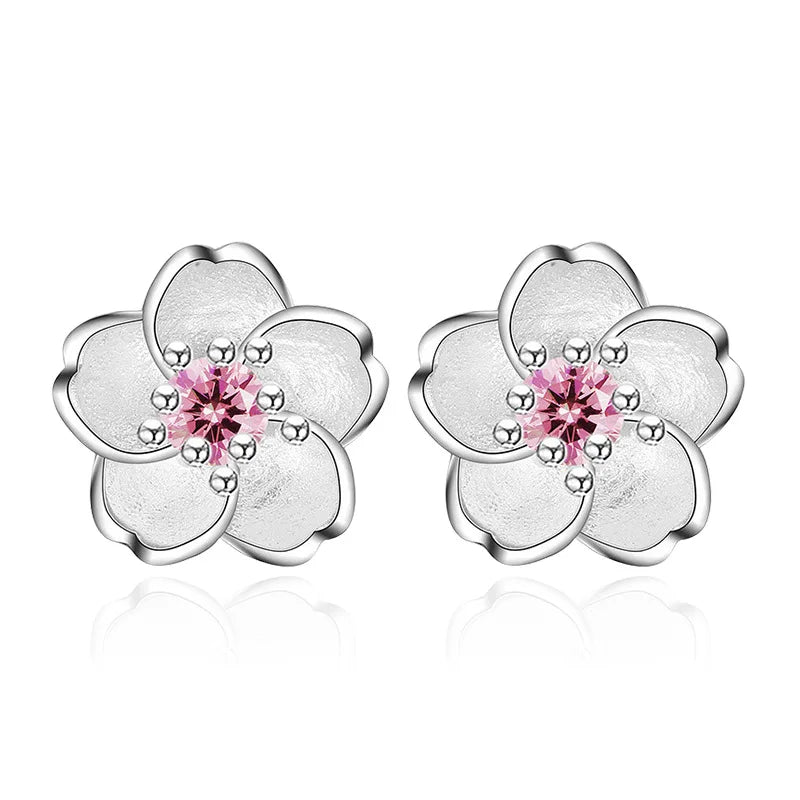 A pair of fine floral stud earrings in polished silver set with pink and purple zirconia stones