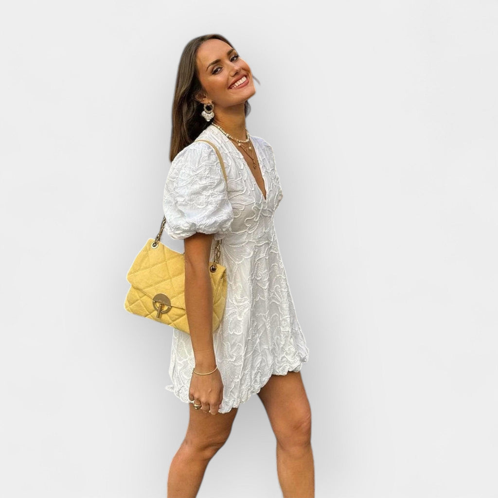Flowing white summer dress with a soft romantic silhouette and gentle movement