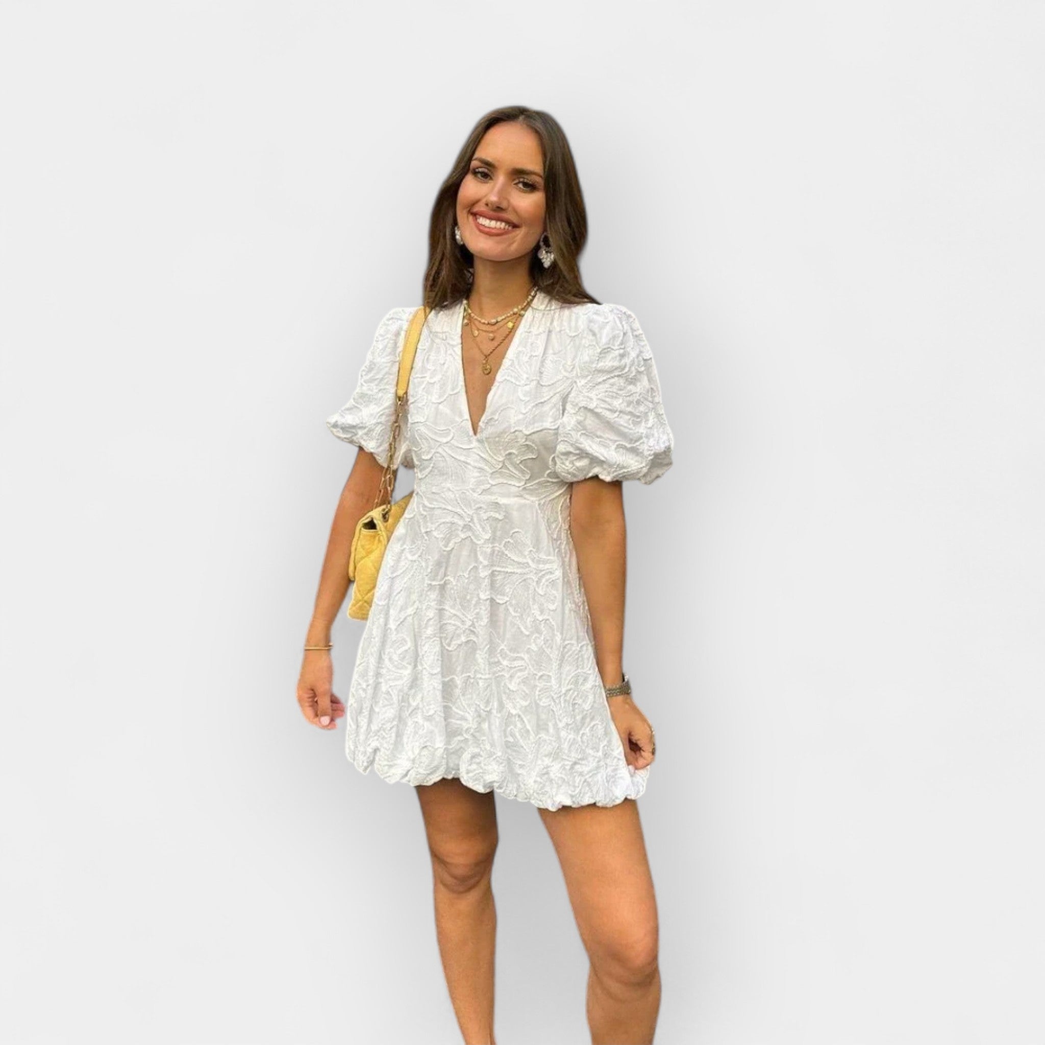 Flowing white summer dress with a soft romantic silhouette and gentle movement