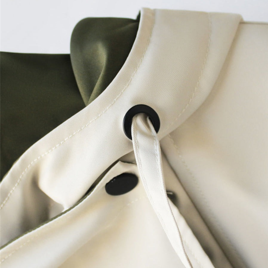 A woman wearing a lightweight weatherproof jacket with an adjustable hem on a blustery day.